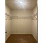 an empty closet with a light on the ceiling
