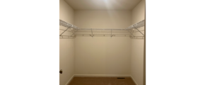 an empty closet with a light on the ceiling