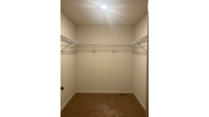 an empty closet with a light on the ceiling
