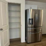 a stainless steel refrigerator in a white kitchen