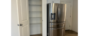 a stainless steel refrigerator in a white kitchen