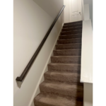 a staircase leading up to a white door
