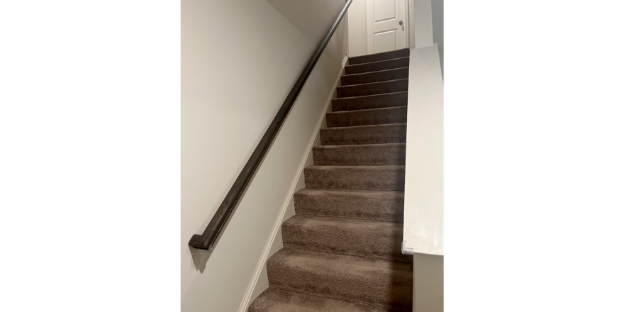 a staircase leading up to a white door