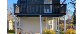 a small house with a balcony on the second floor