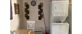 a white refrigerator freezer sitting next to a wooden table