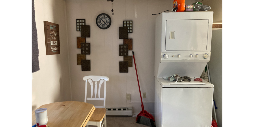 a white refrigerator freezer sitting next to a wooden table