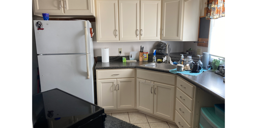 a white refrigerator freezer sitting inside of a kitchen