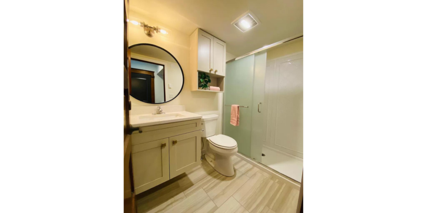 a white toilet sitting next to a walk in shower