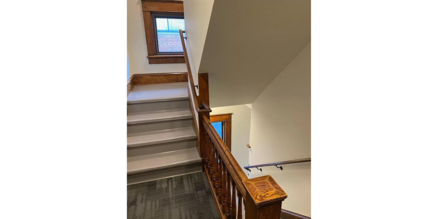 the building staircase leading up to a window in a building