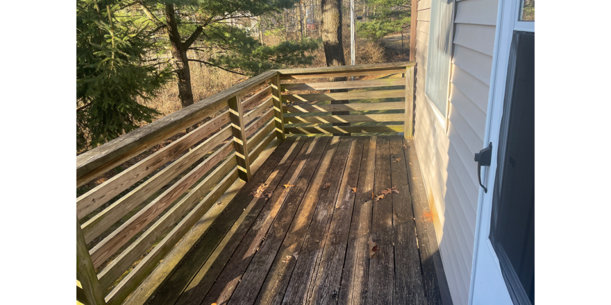 a wooden deck behind the townhouse