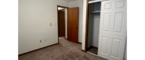 an empty room with a closet and a closet door