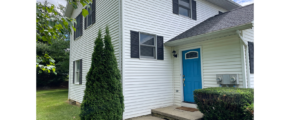 a white house with a blue door