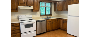 a kitchen with wood cabinets and white appliances