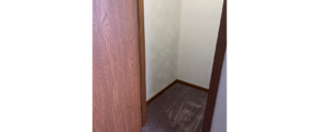 a door is open in a small closet