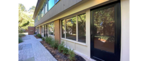 a building with a black door and windows