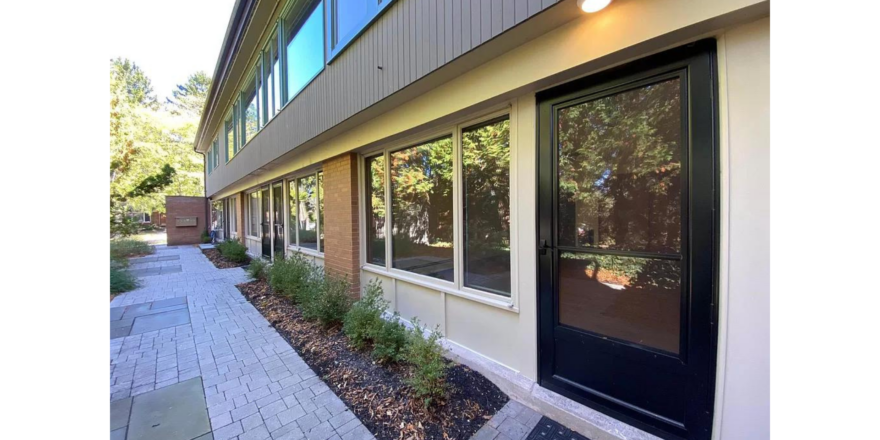 a building with a black door and windows