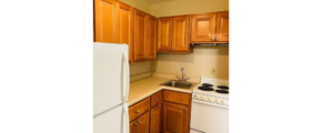 a kitchen with wooden cabinets and white appliances