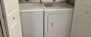 a white washer and dryer in a small room