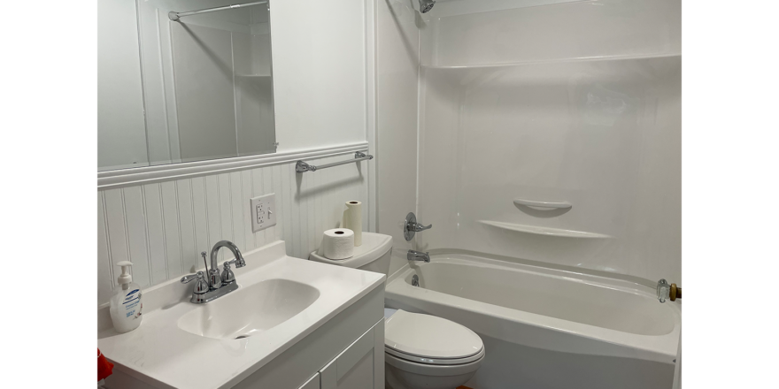 a bathroom with a sink, toilet and bathtub