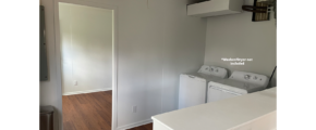 an empty laundry room with washer and dryer