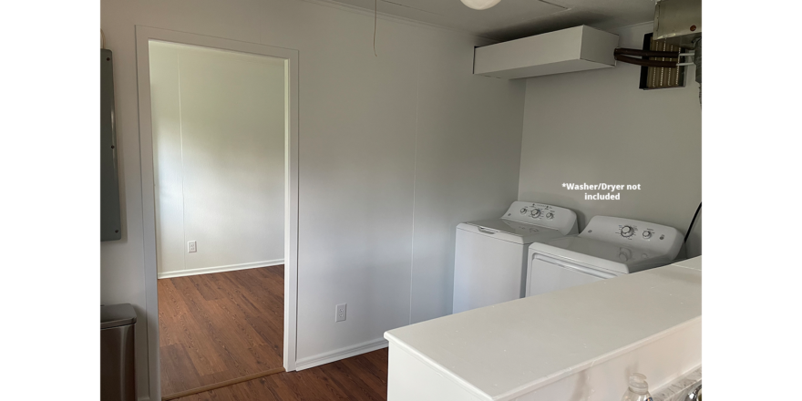 an empty laundry room with washer and dryer