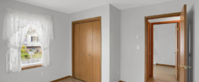 a empty room with a door and a window