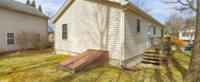 a back yard with a house and a tree