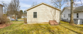 a small house with a yard in front of it