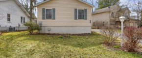 a small house with a yard in front of it