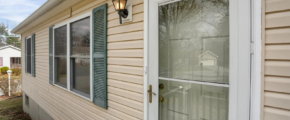 a house with a white front door and green shutters