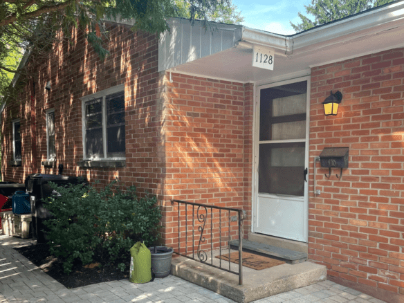 a brick house with a white front door