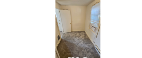 an empty room with carpet and a door