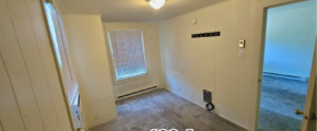 an empty room with a door leading to another room
