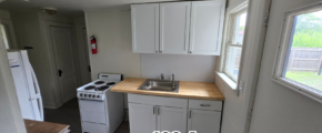 a kitchen with a sink, stove and refrigerator