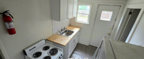 a kitchen with a stove top oven next to a refrigerator