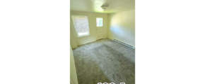 an empty room with a door and a window