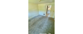 an empty room with a door and a window