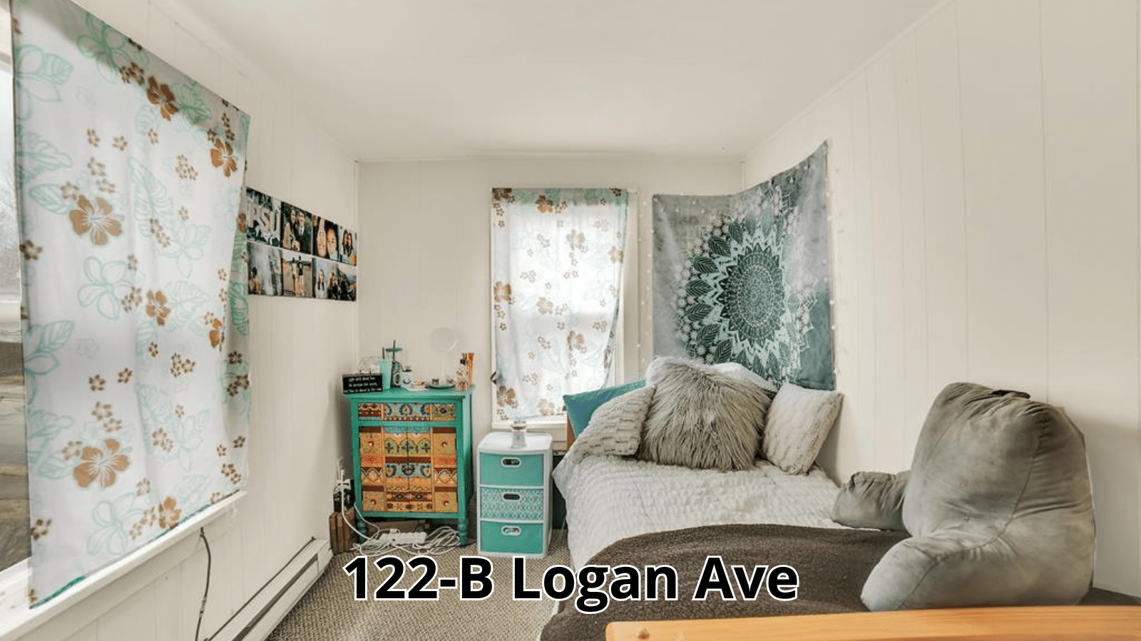 Bedroom with bed, dresser, and tapestries