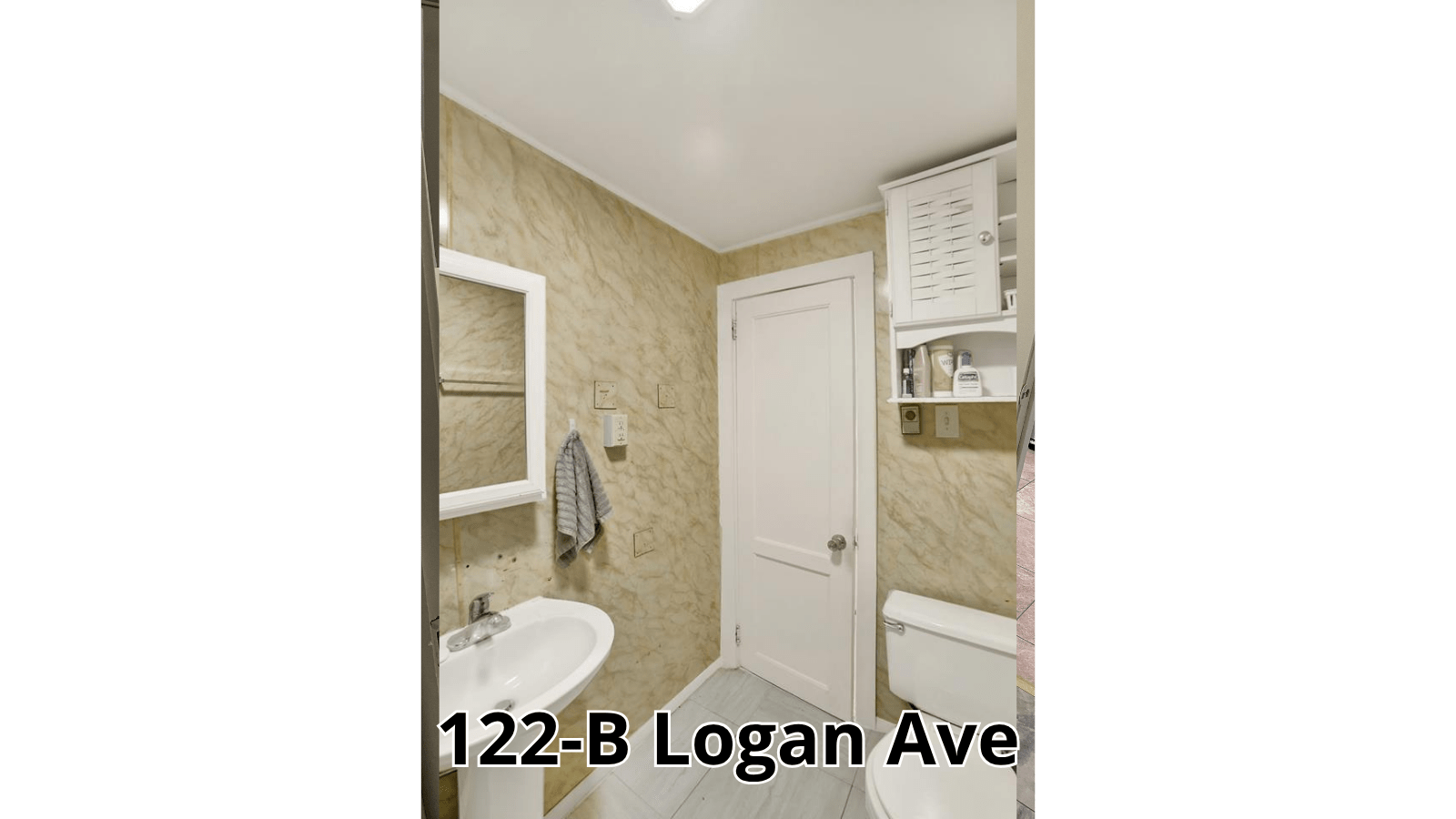 Bathroom with sink, toilet, and cabinet