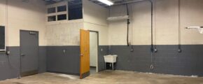 a large room with a door and some lights