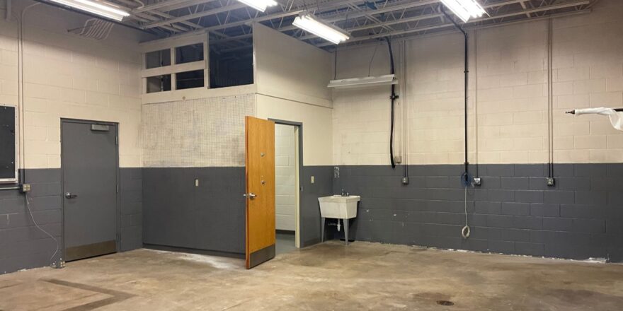 a large room with a door and some lights