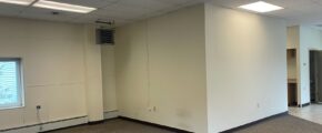 an empty office space with a large window
