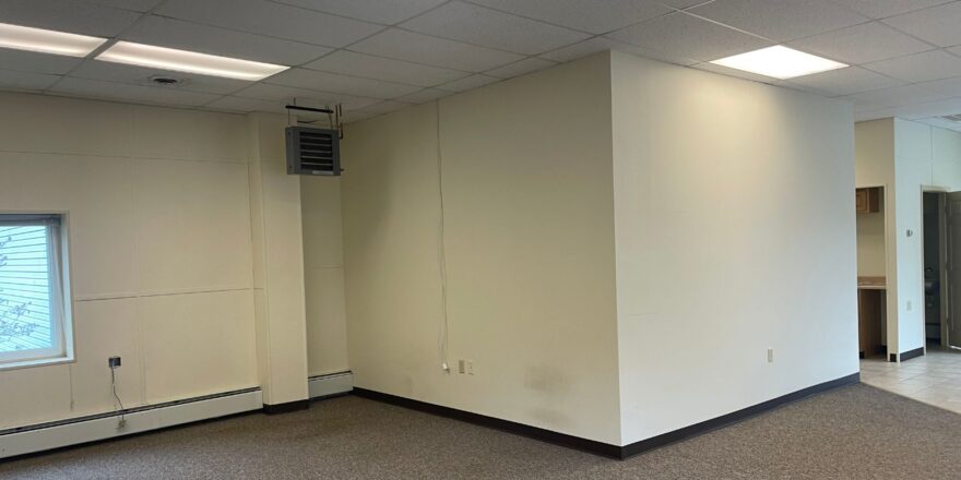 an empty office space with a large window