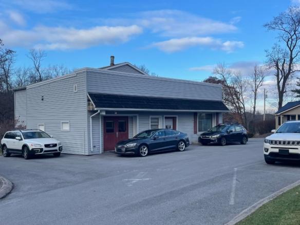 three cars parked in front of a building