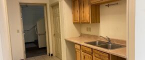 a kitchen with a sink and a refrigerator
