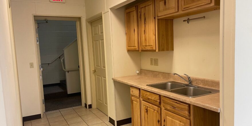 a kitchen with a sink and a refrigerator