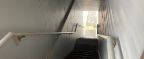 a staircase leading up to the top of a flight of stairs