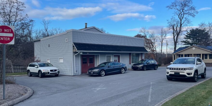 three cars parked in front of a building