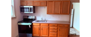 a kitchen with wooden cabinets and black appliances