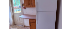 a white refrigerator freezer sitting inside of a kitchen